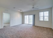 Thumbnail 20 of 25 - a bedroom with a ceiling fan and a door leading to a balcony  at Century Avenues, Lakeland, FL