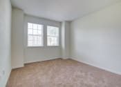 Thumbnail 21 of 25 - a bedroom with two windows and a carpeted floor  at Century Avenues, Lakeland, FL