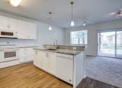 Thumbnail 23 of 25 - a kitchen and living room with a sliding glass door to a balcony  at Century Avenues, Lakeland, Florida