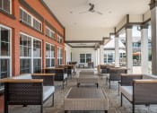 Thumbnail 9 of 29 - a covered patio with tables and chairs at Century Belmont Station, Louisville, Kentucky