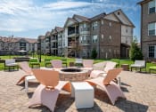 Thumbnail 4 of 29 - an outdoor lounge area with chairs and a fire pit at the enclave at woodbridge apartments in at Century Belmont Station, Louisville, KY