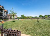 Thumbnail 16 of 29 - a large grassy area with a bench in front of it at Century Belmont Station, Louisville, KY