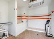 Thumbnail 21 of 29 - a bathroom with white walls and orange and white stripes on the wall at Century Belmont Station, Louisville, Kentucky