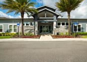 Thumbnail 2 of 30 - the front of a building with palm trees in front of it at Century Dunes Apartments, Deland