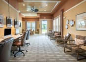 Thumbnail 9 of 30 - a conference room with chairs and a desk and a computer at Century Dunes Apartments, Deland, FL