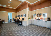 Thumbnail 10 of 30 - a large lobby with a desk and chairs and a counter at Century Dunes Apartments, Deland, 32724