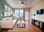 Thumbnail 20 of 30 - a living room with a couch and a coffee table at Century Dunes Apartments, Deland, FL