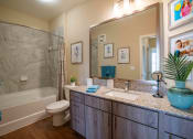 Thumbnail 24 of 30 - a bathroom with a sink and a toilet and a shower at Century Dunes Apartments, Deland, FL, 32724