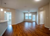 Thumbnail 28 of 30 - an empty living room with a hard wood floor at Century Dunes Apartments, Deland, Florida