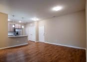 Thumbnail 30 of 30 - an empty living room and kitchen with wood flooring at Century Dunes Apartments, Deland, FL, 32724