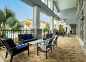 Thumbnail 6 of 30 - a lobby with tables and chairs and a balcony at Century Dunes Apartments, Florida