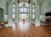 Thumbnail 8 of 30 - spacious living room with large windows and a wood floor at Century Dunes Apartments, Deland