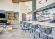 Thumbnail 11 of 32 - take a seat at the bar in the clubhouse at ascend at woodbury new luxury apartments inat Century University City, Charlotte, North Carolina