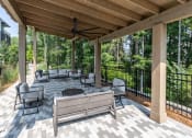 Thumbnail 16 of 32 - a covered patio with couches and chairs at Century University City, Charlotte, 28213