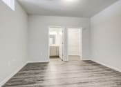 Thumbnail 24 of 32 - a bedroom with gray walls and a wooden floor at Century University City, Charlotte, 28213