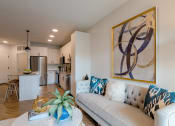 Thumbnail 19 of 28 - a living room with a couch and a coffee table  at Century West Pryor, Lee's Summit, MO