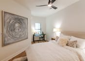 Thumbnail 21 of 28 - a bedroom with a large bed and a ceiling fan  at Century West Pryor, Lee's Summit