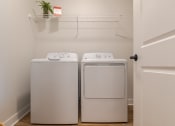 Thumbnail 23 of 28 - a washer and dryer in a laundry room  at Century West Pryor, Missouri, 64081