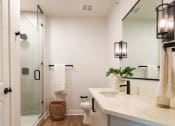 Thumbnail 24 of 28 - a bathroom with white walls and a large mirror  at Century West Pryor, Lee's Summit, 64081