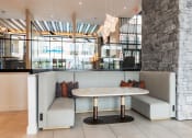 Thumbnail 5 of 28 - a seating area with two couches and a table  at Century West Pryor, Lee's Summit, MO