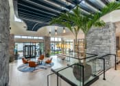 Thumbnail 3 of 28 - a view of the lobby with a large palm tree in the middle of the floor  at Century West Pryor, Missouri