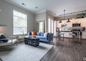 Thumbnail 30 of 62 - A modern living room with a blue sofa and a grey rug.