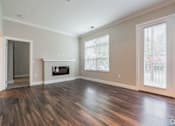 Thumbnail 41 of 62 - A room with a fireplace and wood flooring.