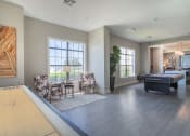 Thumbnail 12 of 29 - a living room with a pool table and two chairs at Century South Shore, League City, TX, 77573