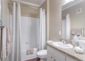 Thumbnail 24 of 29 - a bathroom with a shower toilet and sink at Century South Shore, League City
