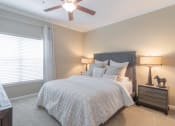 Thumbnail 23 of 29 - a bedroom with a bed and a ceiling fan at Century South Shore, Texas, 77573