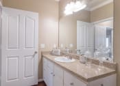 Thumbnail 26 of 29 - a bathroom with a sink and a mirror  at Century South Shore, League City, Texas