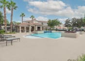 Thumbnail 2 of 29 - a swimming pool with a building in the background at Century South Shore, League City