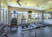Thumbnail 6 of 29 - a gym with cardio equipment and windows  at Century South Shore, League City, Texas