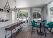 Thumbnail 12 of 27 - a kitchen with a long counter and a long bar with chairs and stools