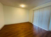 Thumbnail 23 of 30 - a bedroom with white walls and carpet