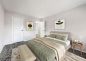 Thumbnail 6 of 18 - A bedroom with a bed, a couch, and two pictures on the wall.