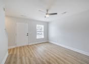 Thumbnail 20 of 25 - A room with a ceiling fan and a door.