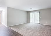 Thumbnail 64 of 81 - living room with sliding glass door and carpet at Magnolia Place at Stockbridge Apartments, Stockbridge