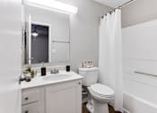 Thumbnail 73 of 81 - a bathroom with a toilet and a sink at Magnolia Place at Stockbridge Apartments, Stockbridge, 30281