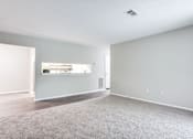 Thumbnail 65 of 81 - an empty living room with hard wood floors and gray walls at Magnolia Place at Stockbridge Apartments, Stockbridge, Georgia