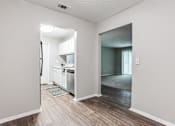 Thumbnail 66 of 81 - a view of a kitchen and living room from a doorway at Magnolia Place at Stockbridge Apartments, Stockbridge, GA