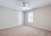 Thumbnail 70 of 81 - bed room with a ceiling fan and a window at Magnolia Place at Stockbridge Apartments, Stockbridge, GA, 30281