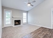 Thumbnail 47 of 81 - an empty living room with a fireplace at Magnolia Place at Stockbridge Apartments, Stockbridge, 30281