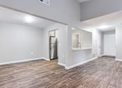 Thumbnail 49 of 81 - the living room and kitchen of a new home with wood flooring at Magnolia Place at Stockbridge Apartments, Georgia