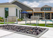 Thumbnail 17 of 36 - A modern house with a pool and a fire pit in the backyard.