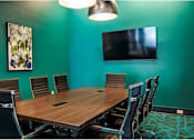 Thumbnail 20 of 36 - A conference room with a long table and chairs.