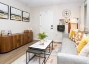 Thumbnail 5 of 14 - a living room with a gray couch and a coffee table