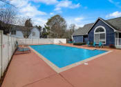 Thumbnail 32 of 37 - a swimming pool with a house and a fence around it at The Sapphire, Decatur, GA, 30035
