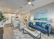 Thumbnail 1 of 39 - a living room with a couch and a coffee table at Century Mundy Mill Apartments, Oakwood, GA