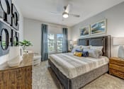Thumbnail 7 of 39 - a bedroom with a bed and a window at Century Mundy Mill Apartments, Georgia 30566